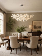 Gingko leaf chandelier with porcelain leaves over a dining table