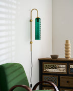 glass wall lamp styled wall view with the glass cylinder softly glowing