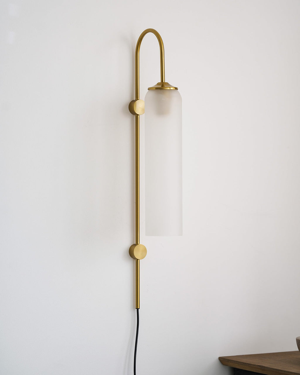 glass wall lamp glowing softly in a furnished room