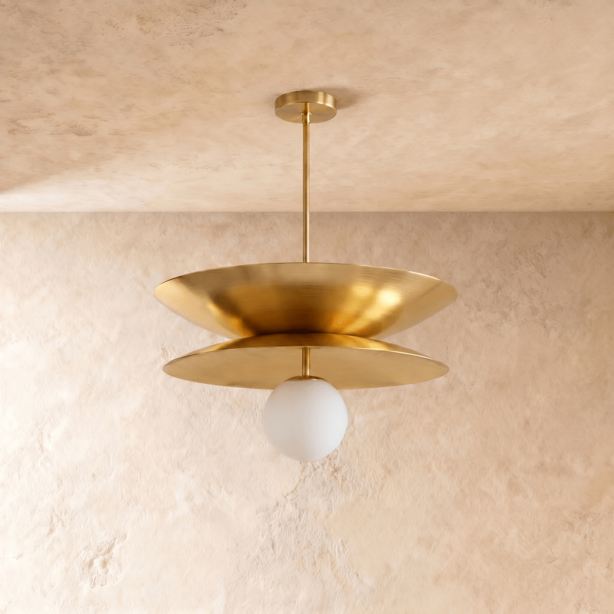 Clérachic double-disc pendant light in brass, a fine circular grain catching a soft sheen across the upper disc.