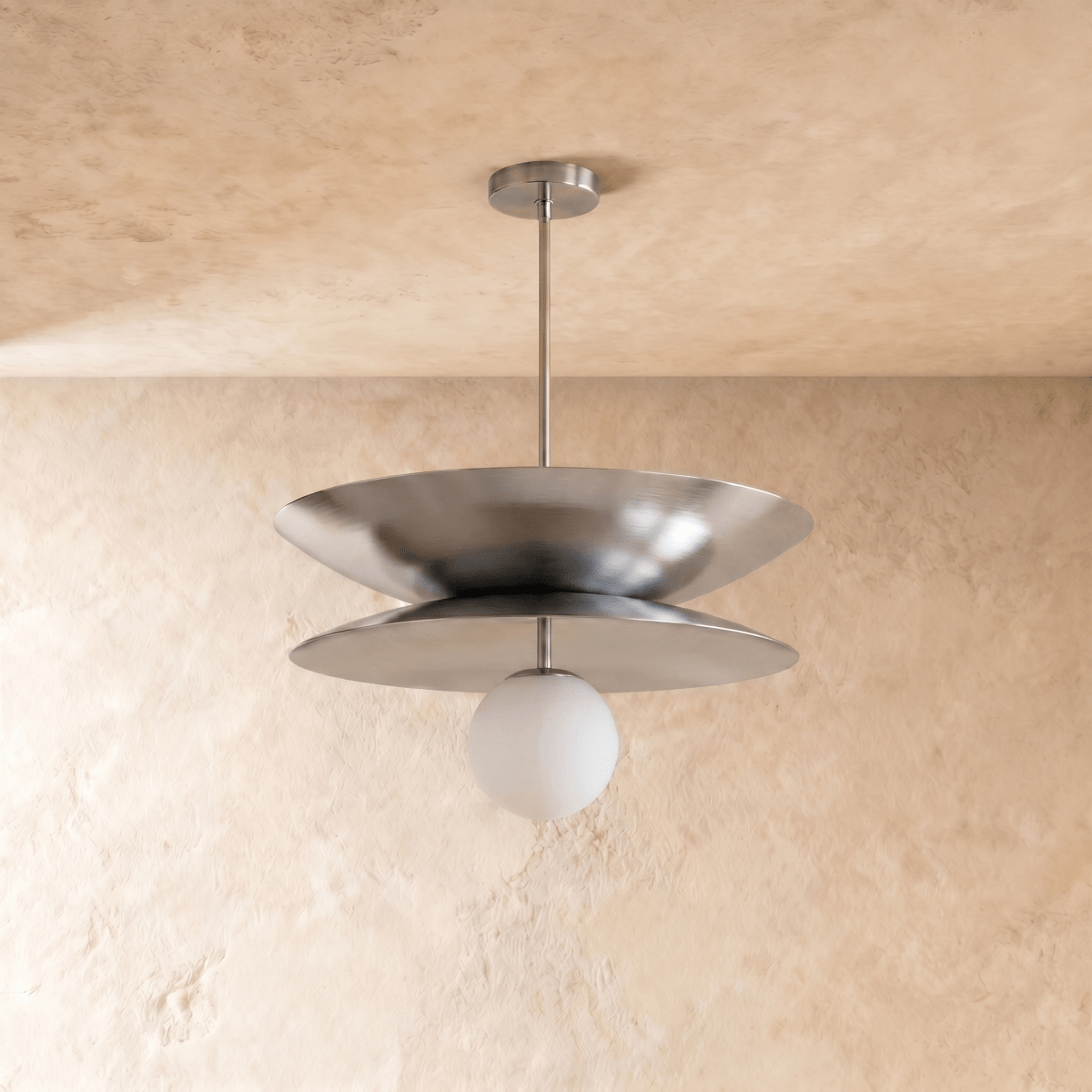 Clérachic layered-disc pendant light in chrome, a bright highlight running along the rim of its lower disc.