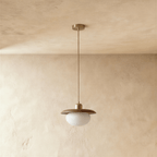 Clérachic pendant light switched off, its opal glass reading plain matte white beneath the wood disc.