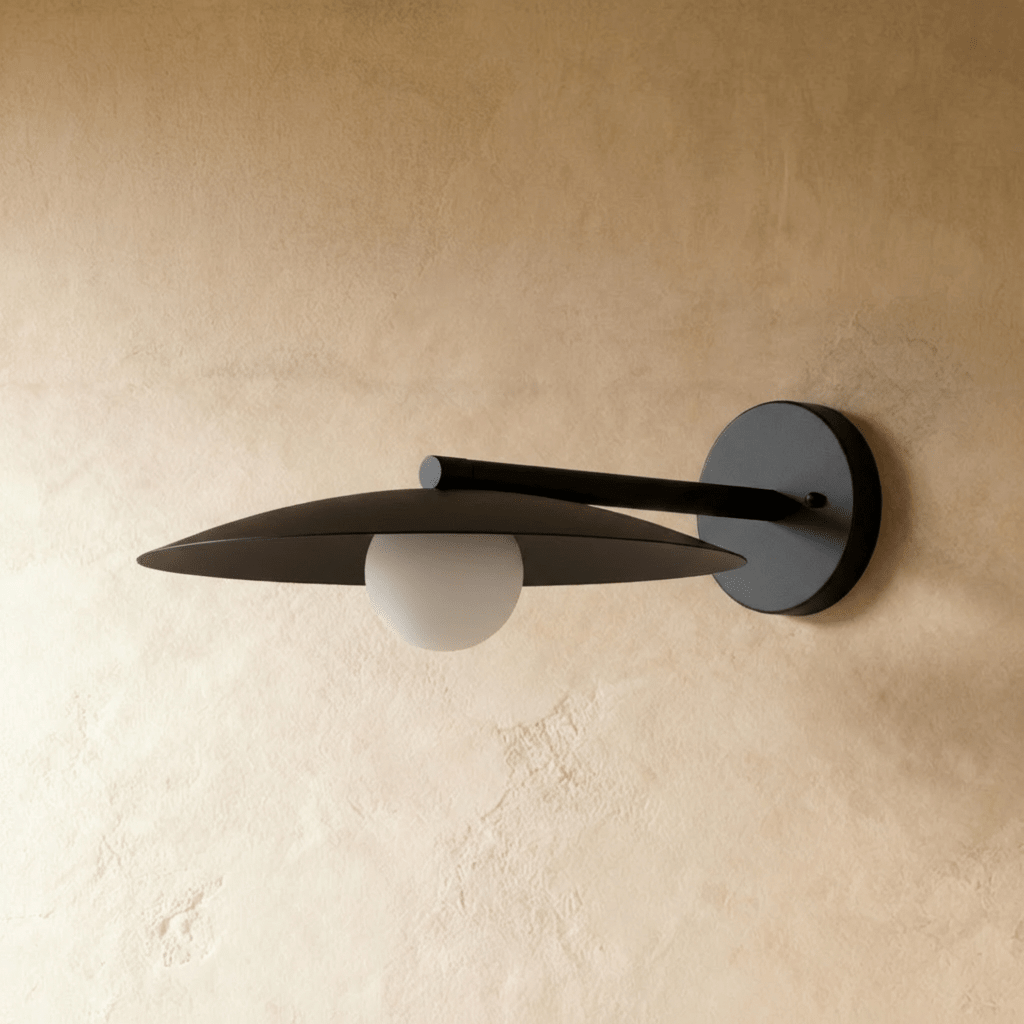 Clérachic wall lamp in black, the unlit white globe hanging at the centre of the round dish shade.