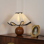 Wavecrest table lamp with linen shade beside decor accents