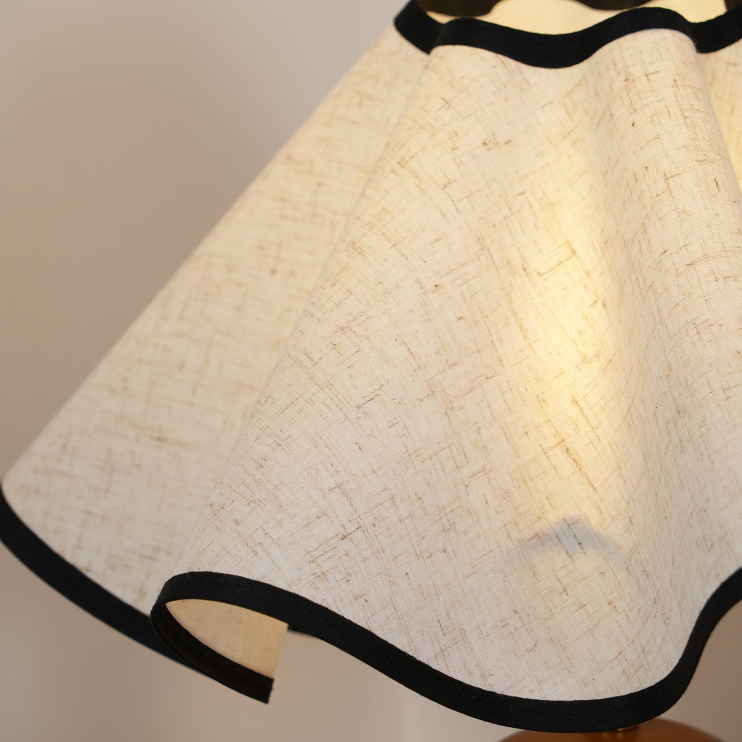 Wavecrest table lamp lit on a side table near a window