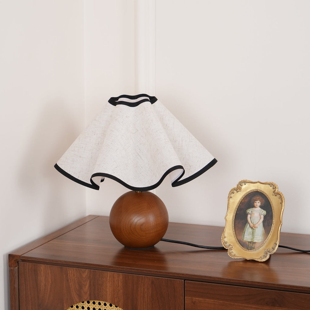 Wavecrest table lamp on a wooden surface in a styled room